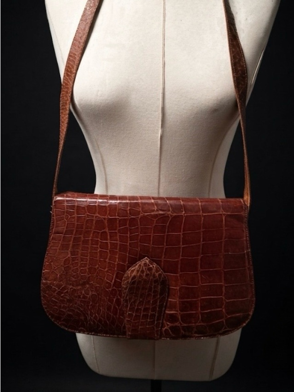 Vintage alligator handbag features a unique textured finish and a distinct